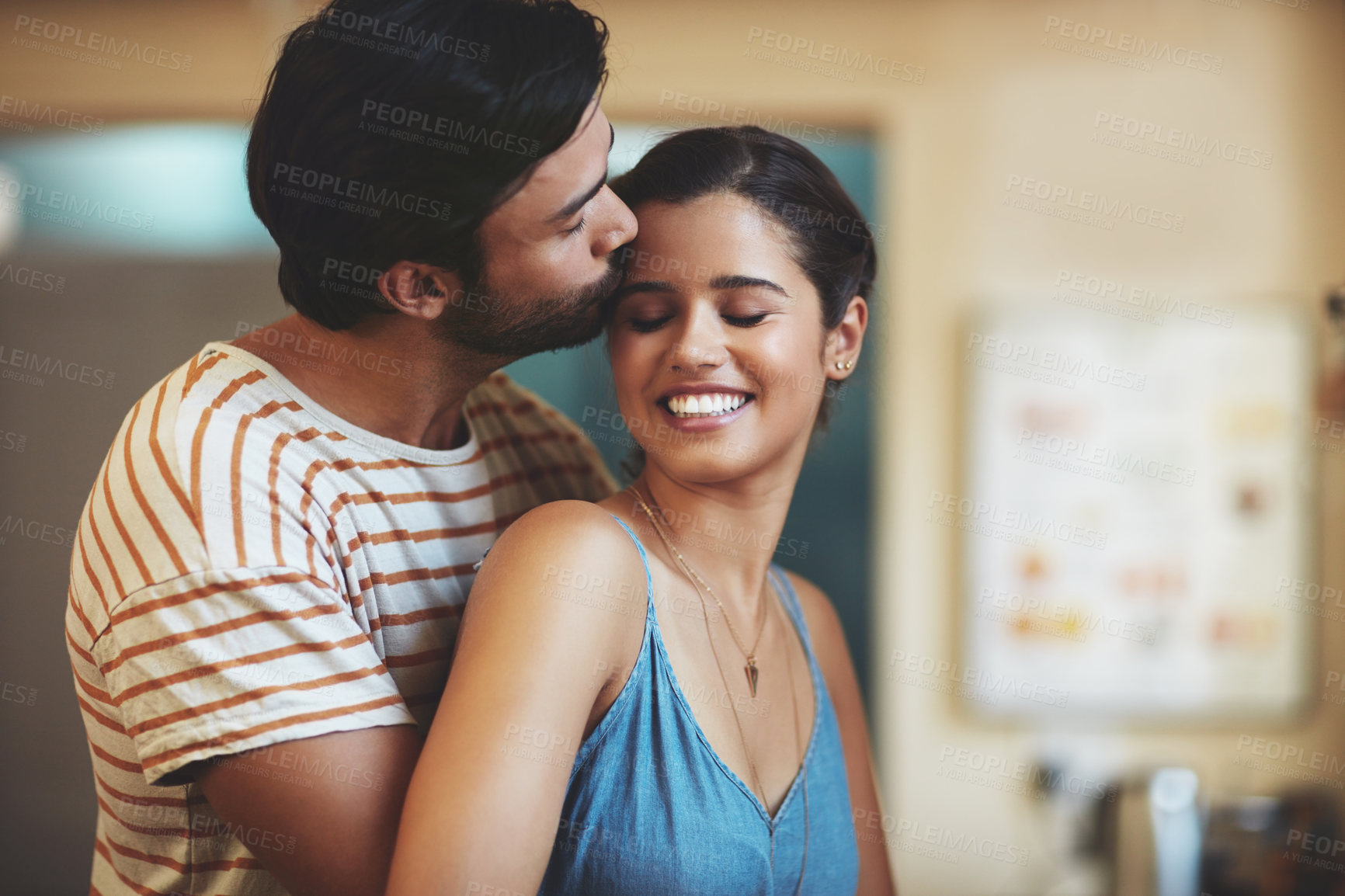 Buy stock photo Couple, love and forehead kiss in home for relationship loyalty, romance and bonding together. Man, happy woman and hug in kitchen for partnership with kindness, care and support for healthy marriage