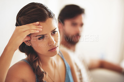 Buy stock photo Unhappy, upset or conflict with a couple arguing about an affair or breakup on their home living room sofa. Depression, abuse or domestic violence with a sad woman thinking of divorce after a fight