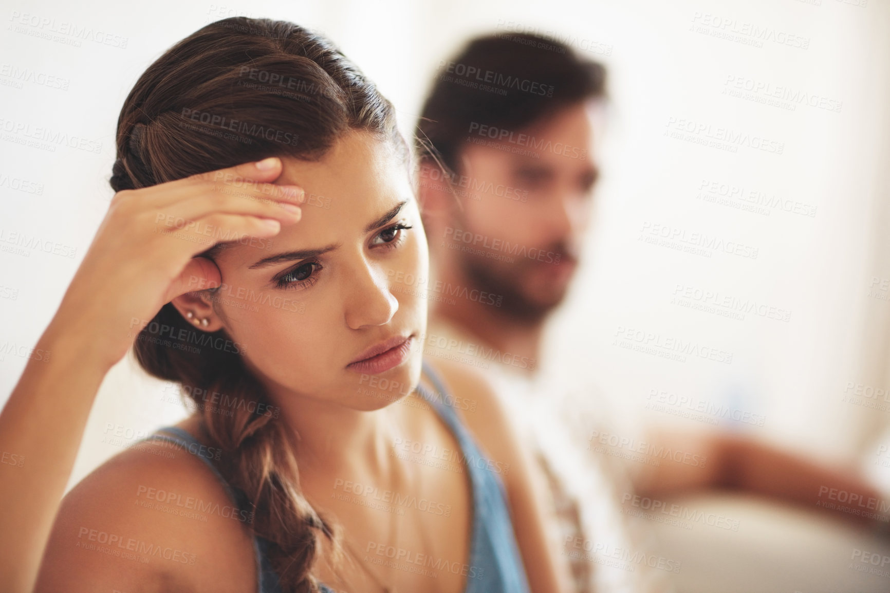 Buy stock photo Unhappy, upset or conflict with a couple arguing about an affair or breakup on their home living room sofa. Depression, abuse or domestic violence with a sad woman thinking of divorce after a fight