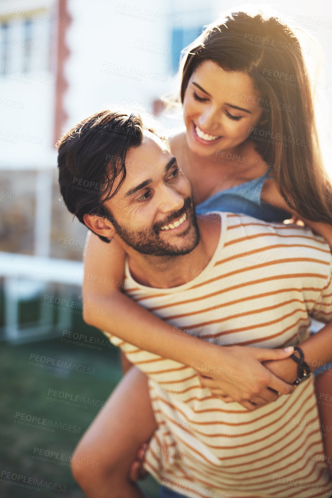 Buy stock photo Couple, piggy back and outdoor in summer with smile, bonding and connection on vacation with care. Man, woman and happy with carrying, hug and love in sunshine for funny memory with play in garden