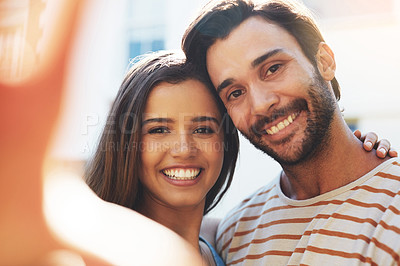 Buy stock photo Shot of an affectionate young couple spending a day together outside