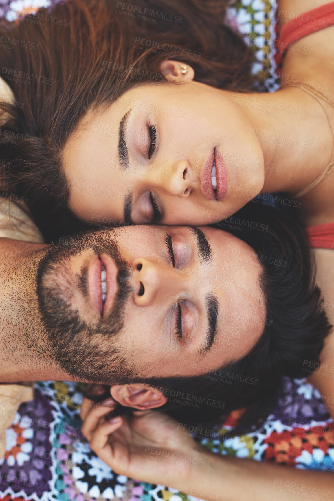 Buy stock photo High angle portrait of a happy young couple relaxing on a blanket outside