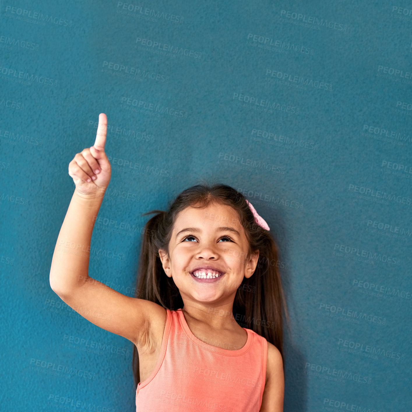 Buy stock photo Pointing up, excited and child in studio with mockup space for omg news, opinion and feedback. Emoji, surprise and isolated, happy and girl with announcement, information and deal on blue background