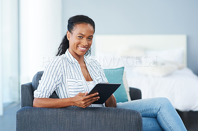 Buy stock photo Portrait of a young woman using a digital tablet at home