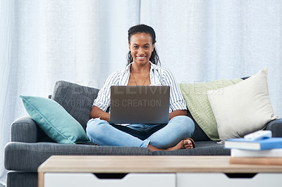 Buy stock photo Portrait of a young woman using a laptop at home