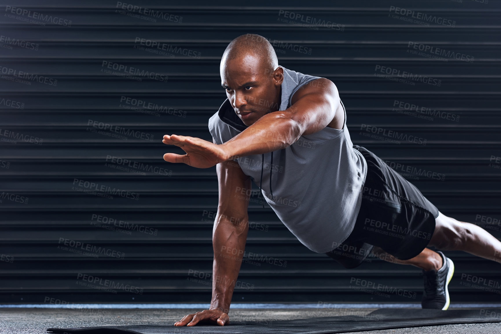 Buy stock photo Shot of a handsome young man doing push-ups
