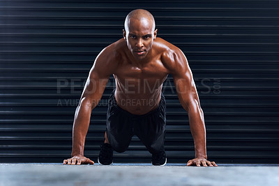 Buy stock photo Shot of a sporty young man doing push ups