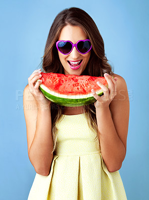 Buy stock photo Studio shot of a beautiful woman holding a watermelon against a blue background