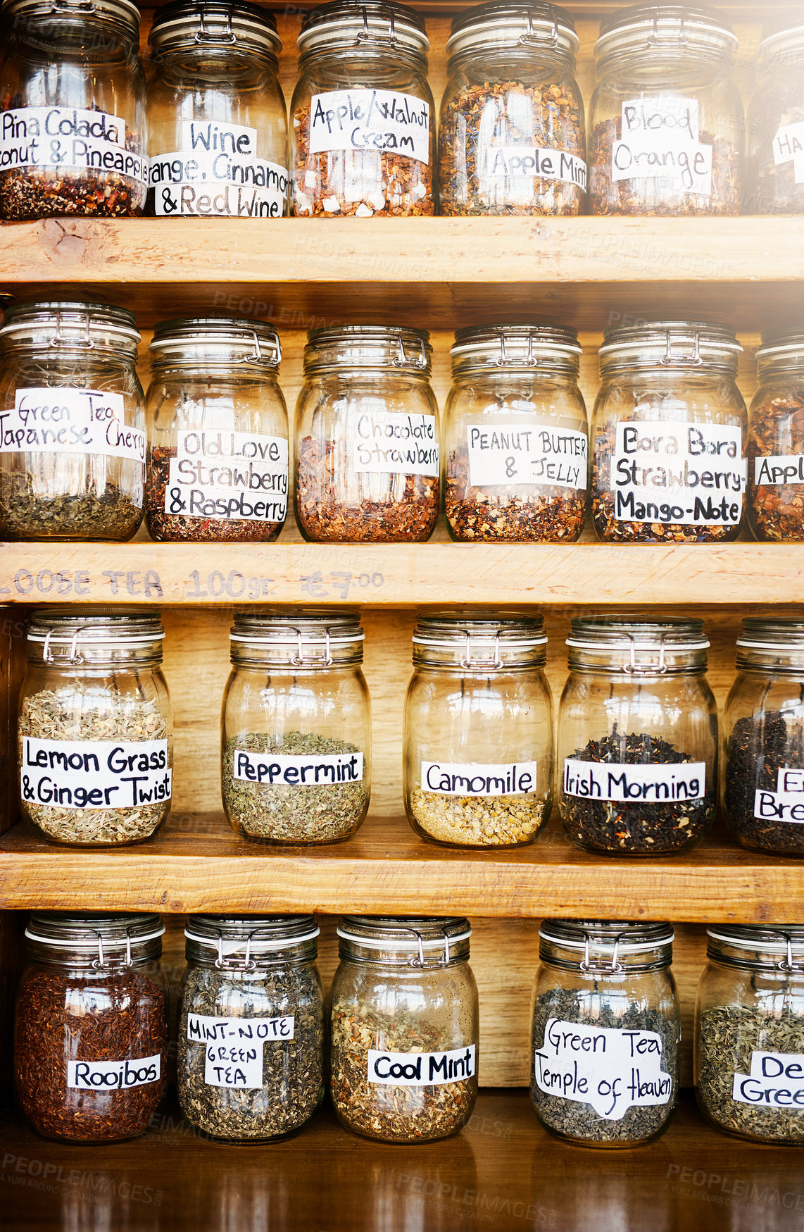 Buy stock photo Glass, tea jar and shelf at cafe for catering, flavor and organic leaves for drinks in store. Container, antioxidant and natural herbs with stock, inventory and label with beverage at coffee shop