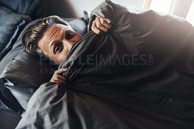Buy stock photo Shot of a handsome young man relaxing in bed at home