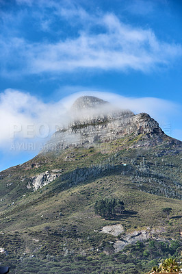 Buy stock photo Copyspace with view of Lions Head mountain in Cape Town South Africa against a cloudy blue sky background from below on a misty morning. Magnificent scenery of an iconic and famous travel destination