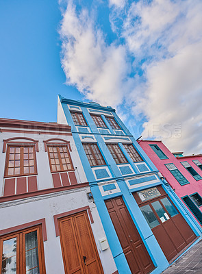 Buy stock photo Colorful buildings in the streets of Santa Cruz de La Palma. Houses or homes built in a vintage architecture design in a small town or village. Vibrant city with cloudy blue sky and copyspace