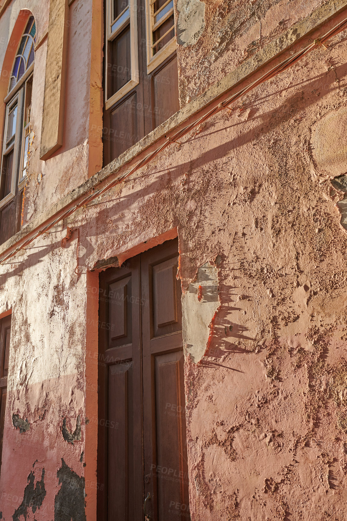 Buy stock photo Exterior of an old building with peeling paint. Architecture details of an ancient, weathered rustic residential build with vintage wooden doors and windows in Santa Cruz de La Palma