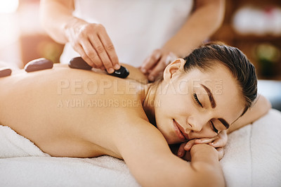Buy stock photo Therapy, relax and woman getting a hot stone back massage at spa for luxury, calm and natural self care. Beauty, body care and tranquil female person sleeping while doing rock body treatment at salon