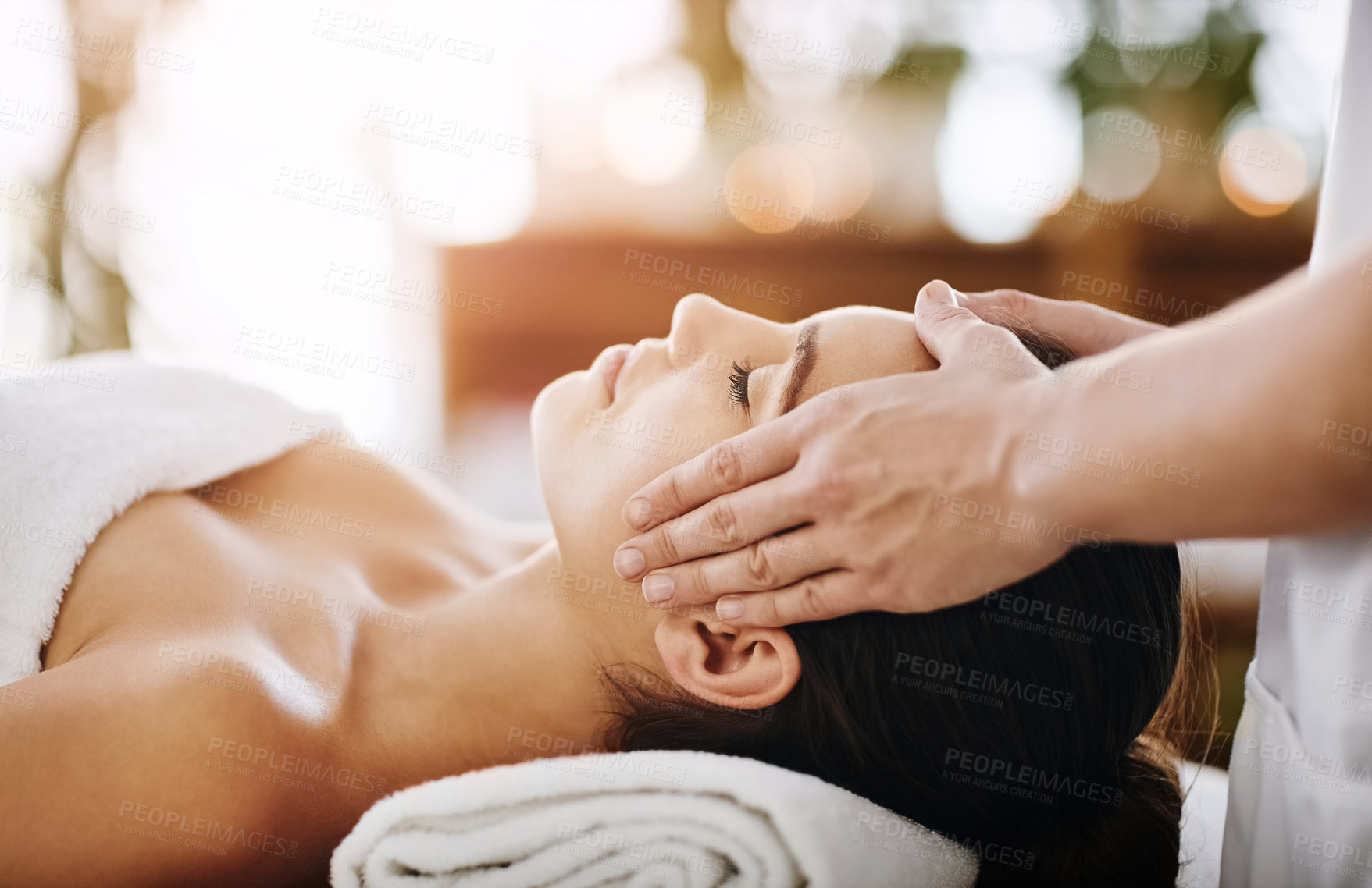 Buy stock photo Head massage, hands and woman in spa for relax, calm and treatment for client on bed. Towel, face and lymphatic drainage on salon table by masseuse person, facial and cosmetic therapy service