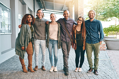 Buy stock photo Portrait of a group of happy young students standing together outdoors on campus