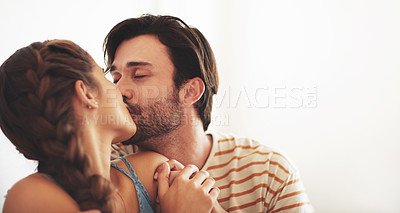 Buy stock photo Couple, love and kiss in home for care, romance and bonding together to relax in apartment. Morning, man and intimate woman with healthy relationship, connection and support on white wall background