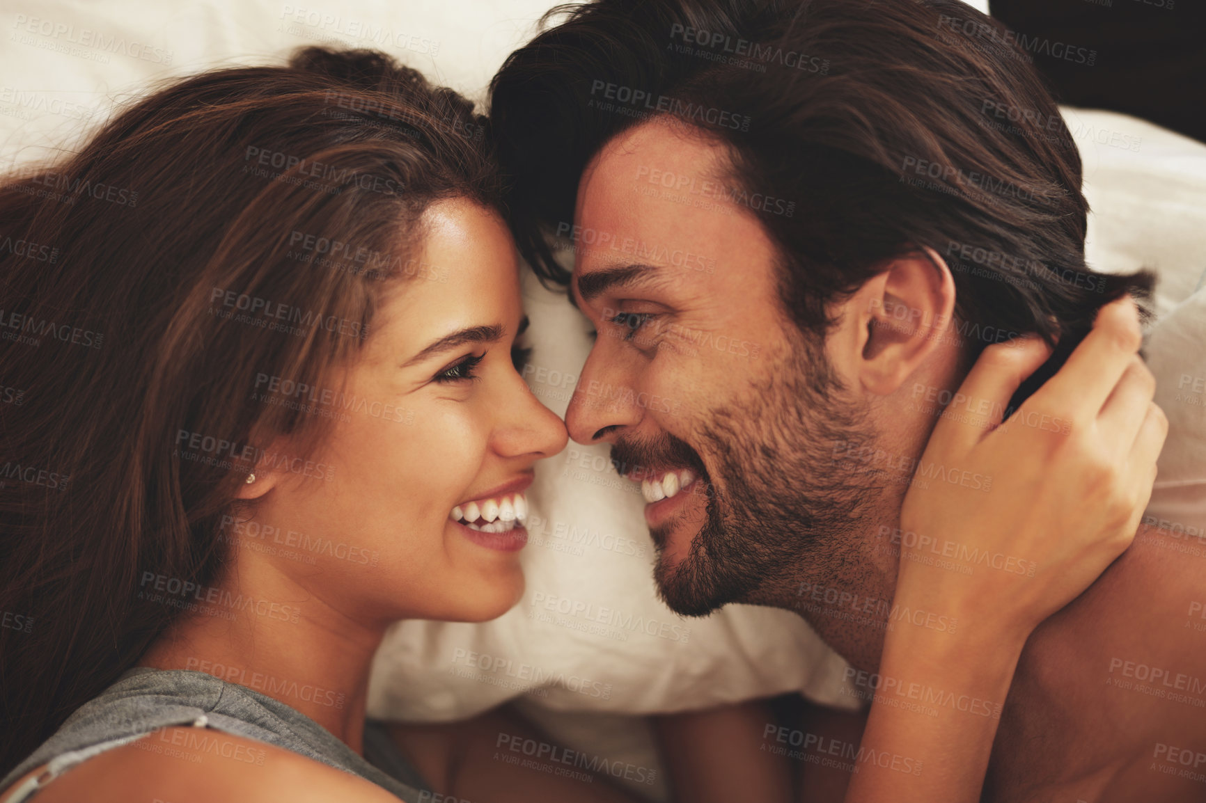 Buy stock photo Happy couple and affection with smile, intimacy and love in home for bonding, relax and sleep on weekend. Woman, man and connection for marriage, commitment and partner  with happy, care and bedroom