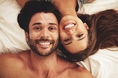 Buy stock photo Love, portrait and couple on bed in home for relaxing morning on weekend together from above. Happy, smile and high angle of young man and woman resting in bedroom for bonding and connection at house