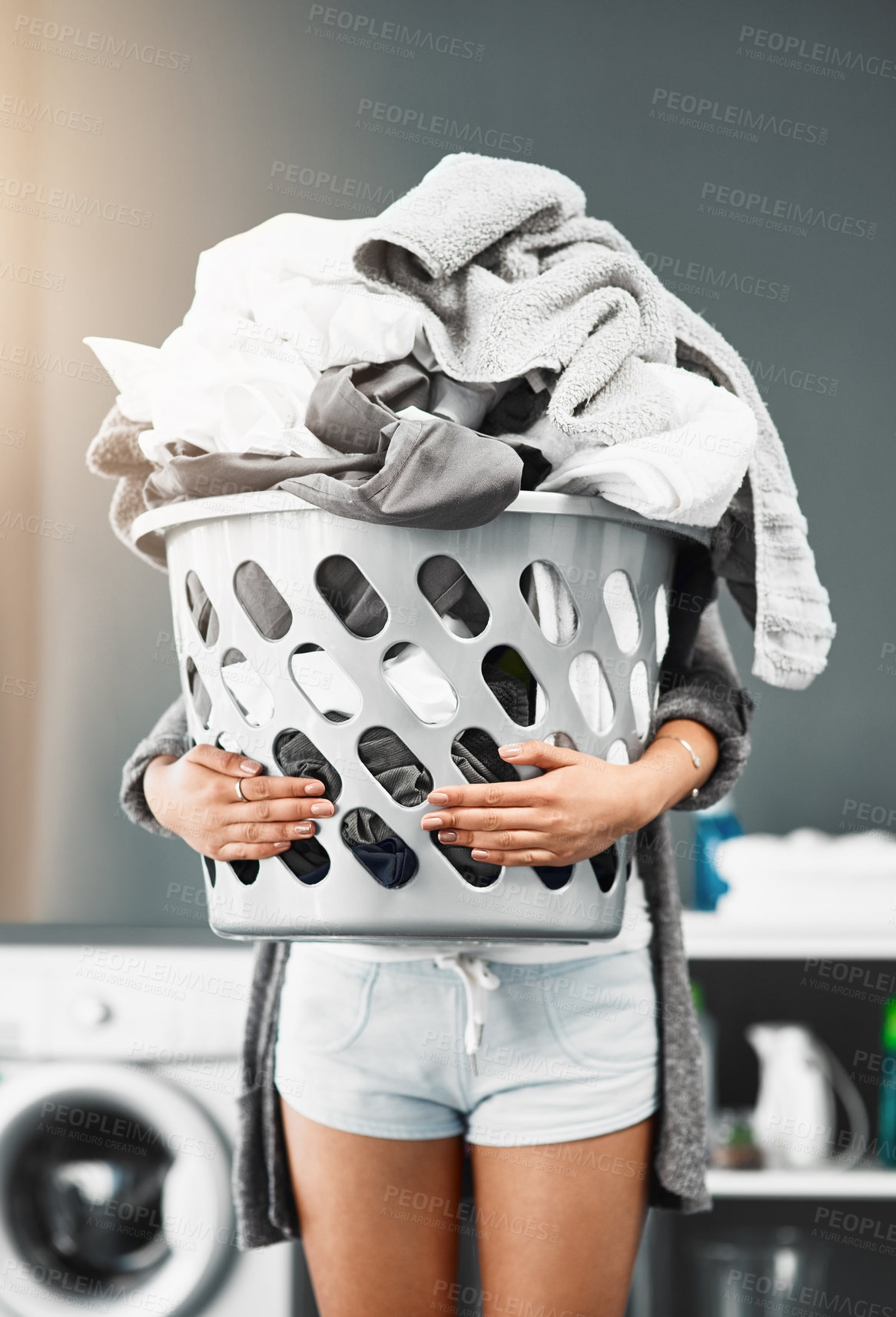 Buy stock photo Laundry basket, pile and woman with clothes in her home for housework, washing and hygiene. House, cleaning and female carrying fresh fabric for spring clean, tidy and household task on the weekend