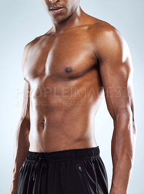 Buy stock photo Studio shot of an unrecognizable young athletic man posing against a grey background