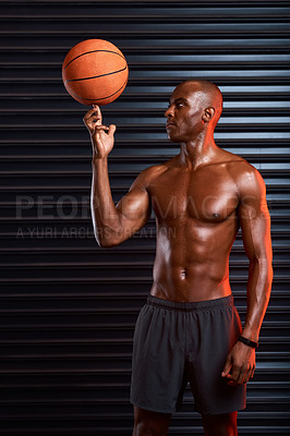 Buy stock photo Studio shot of an athletic young man playing with  a basketball against a grey background