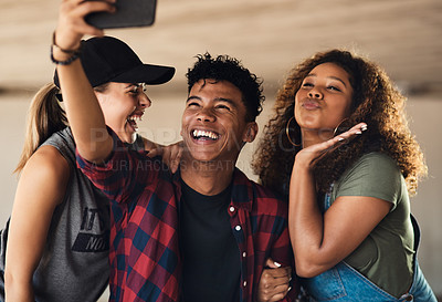 Buy stock photo Portrait of a group of cheerful young friends posing for a self portrait together while outside in a parking lot