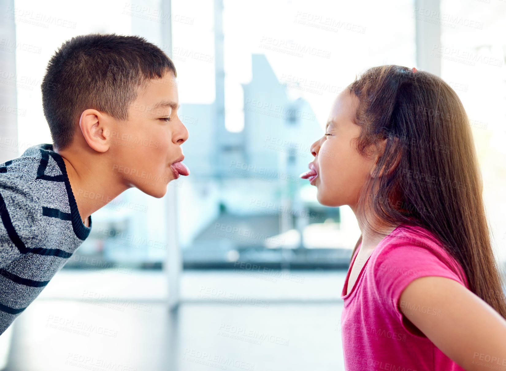 Buy stock photo Children, fight or silly with tongue out, problem or frustrated with youth at home in living room. Young, argument or conflict in house, apartment or bedroom with kids for child development or growth