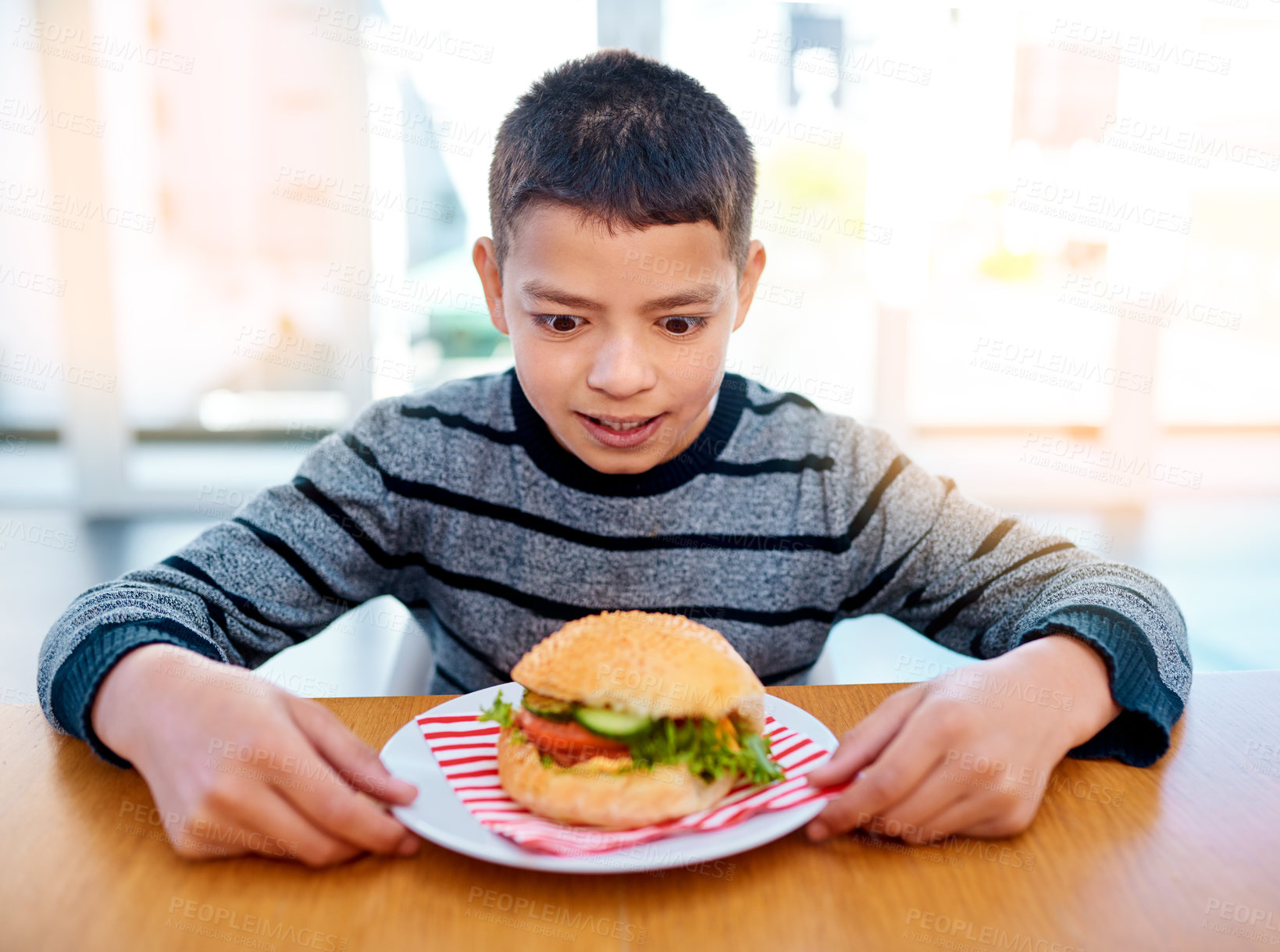Buy stock photo Child, food and thinking about eating burger at table for wellness, development and nutrition. Kid, hamburger and appetite in kitchen for lunch, meal and healthy for young boy, beef and vegetables.