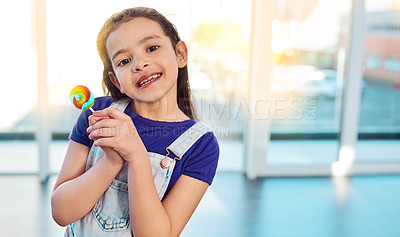 Buy stock photo Portrait, smile and girl with lollipop, home and sweets for child, growth and development with snack. Candy, sugar and happiness of kid, eating and excited to enjoy, cute and dessert in house
