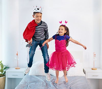 Buy stock photo Bed, playing and children in dress up jump for sibling bonding, relax and fun together. Family, happy and young girl and boy for childhood, youth or playful on holiday, weekend or vacation in costume