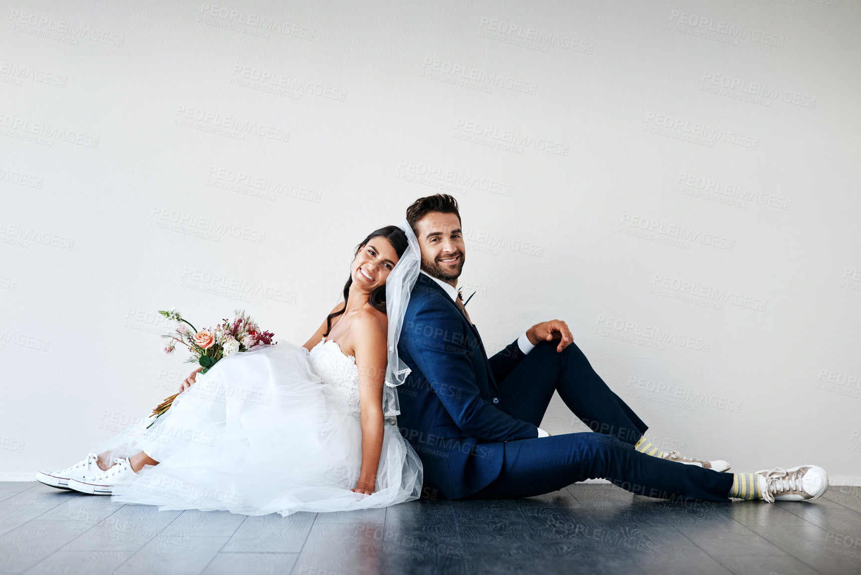 Buy stock photo Bride, groom and smile mockup for marriage with flower bouquet, wedding and celebration together. Happy couple, unity and commitment for love, excited and portrait on floor and white wall background