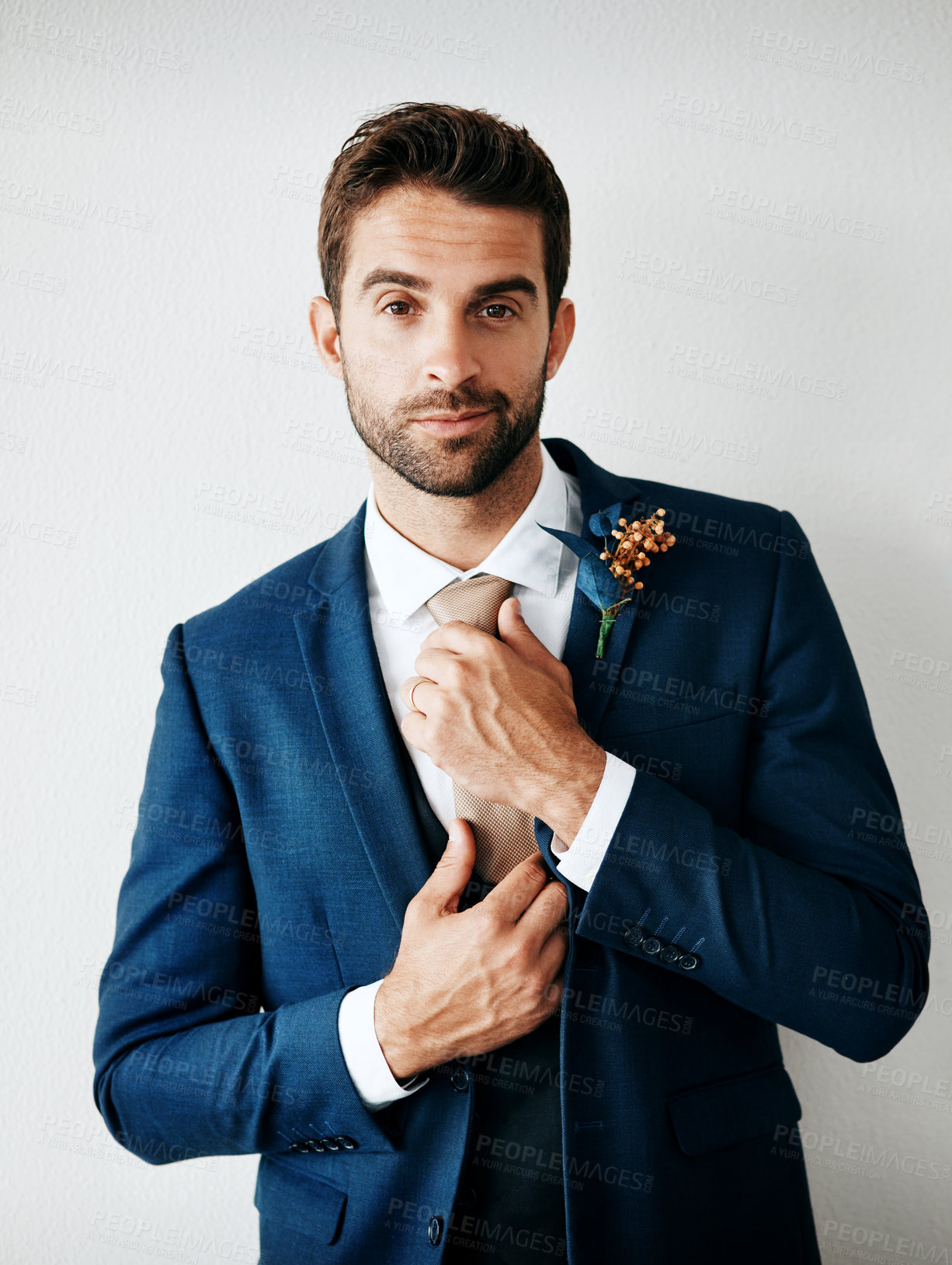 Buy stock photo Portrait, fashion and suit with man getting reading for marriage ceremony against white wall background. Event, luxury and groom dressing in tie, smart or formal for love celebration and commitment