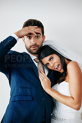 Buy stock photo Studio shot of a newlywed couple standing against a gray background
