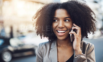 Buy stock photo Shot of a young businesswoman talking on a cellphone in the city