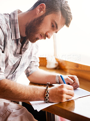 Buy stock photo Cropped shot of a shop owner doing paperwork in his cafe