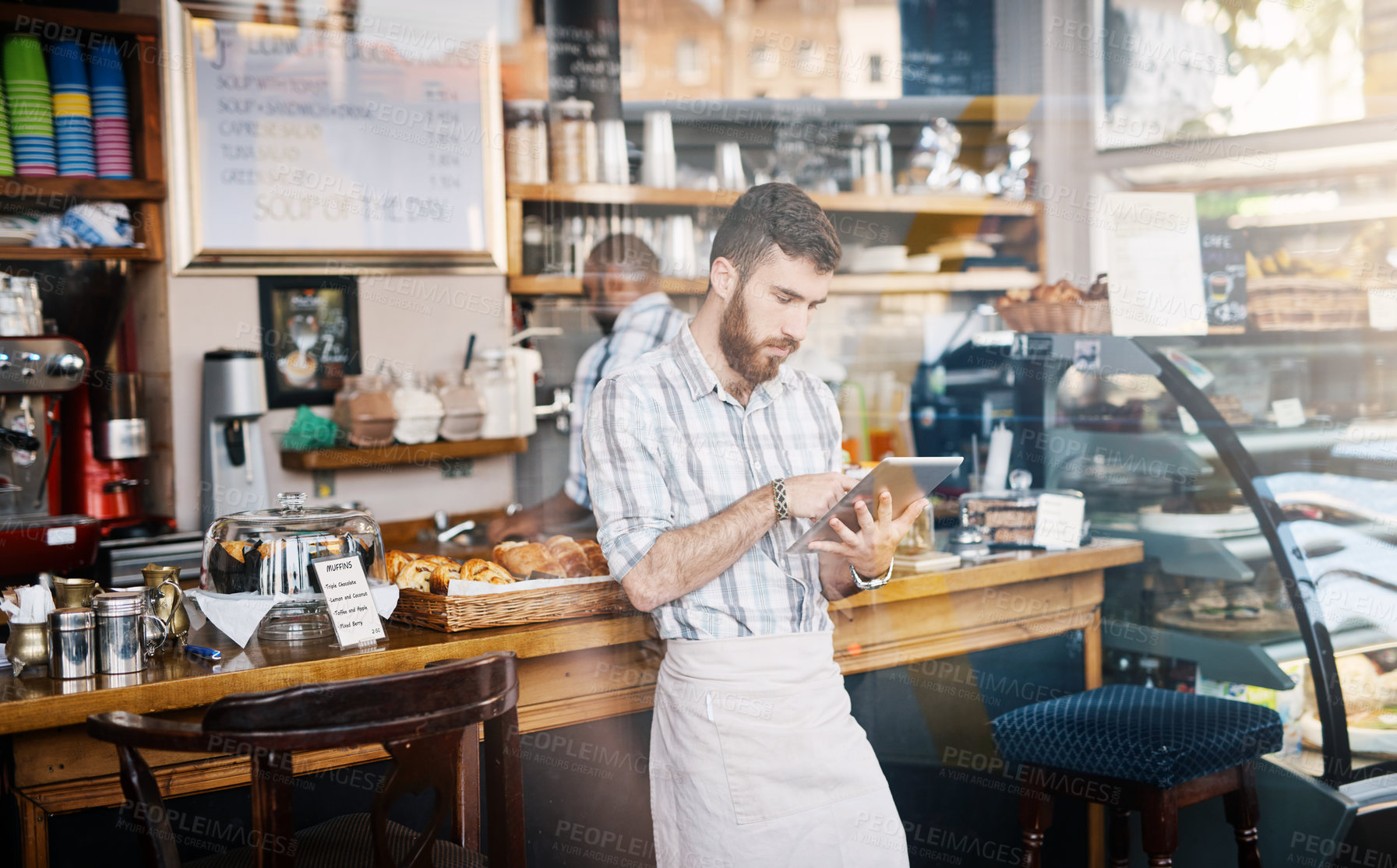 Buy stock photo Tablet, small business and barista doing inventory while working on startup plan in restaurant. Technology, entrepreneur and male cafe owner and waiter doing research on digital mobile in coffee shop