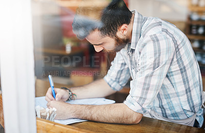 Buy stock photo Man, coffee shop and window with paperwork for small business as manager for inventory or stock. Male person, writing and planning for food menu, restaurant or bistro as owner in hospitality industry