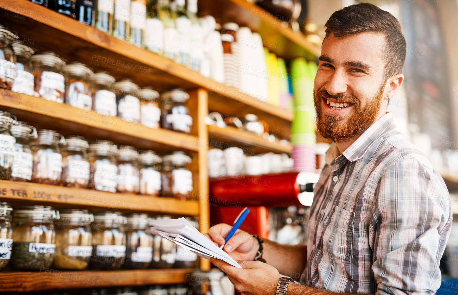 Buy stock photo Man, writing and shop owner in portrait at cafe by shelf, paperwork and inspection for stock with smile. Person, entrepreneur and documents with notes, inventory and restaurant management in Turkey