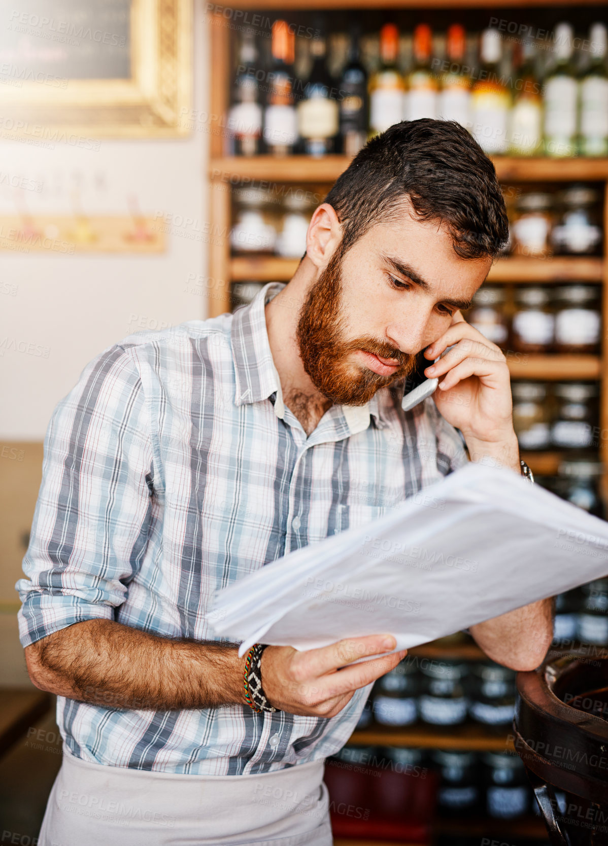 Buy stock photo Man, phone call and shop owner in cafe with documents, thinking and reading for price, stock and deal. Barista, smartphone and paperwork for invoice, inventory and contact supplier in restaurant