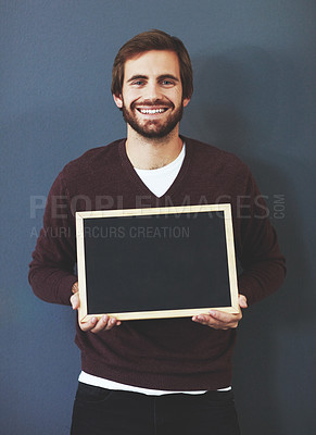 Buy stock photo Happy, portrait and man with chalkboard for mockup space with marketing, promotion or advertising. Smile, career and male teacher from Canada with sign for education isolated by studio background.