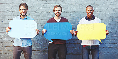 Buy stock photo Portrait of a group of young men holding speech bubbles against a brick wall
