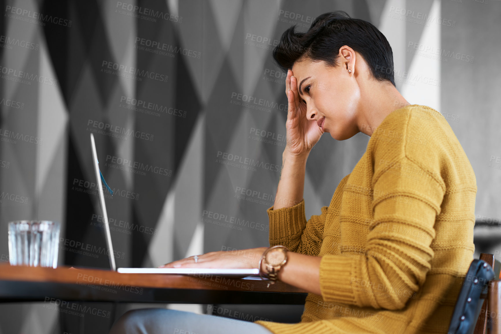 Buy stock photo Cropped shot of an attractive young businesswoman looking stressed out while working in her office