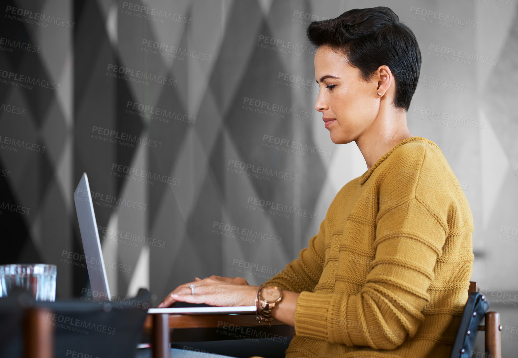 Buy stock photo Cropped shot of a confident and attractive young businesswoman working in her office