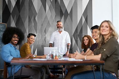 Buy stock photo Cropped portrait of a group creative colleagues sitting in the boardroom during a meeting