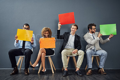 Buy stock photo Full length shot of a group of young creative businesspeople holding up blank placards in their office