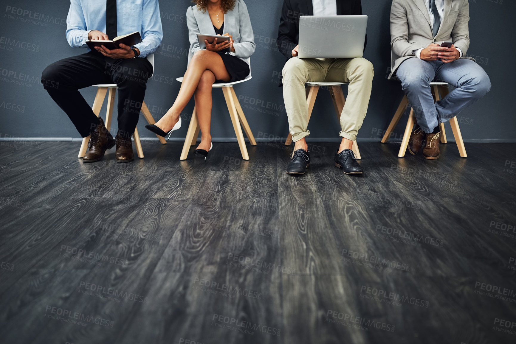 Buy stock photo Waiting room, legs and business people for job interview, recruitment and hiring on chair in line. Job seeker, digital tech and notebook for preparation, resume info and candidates of hr office