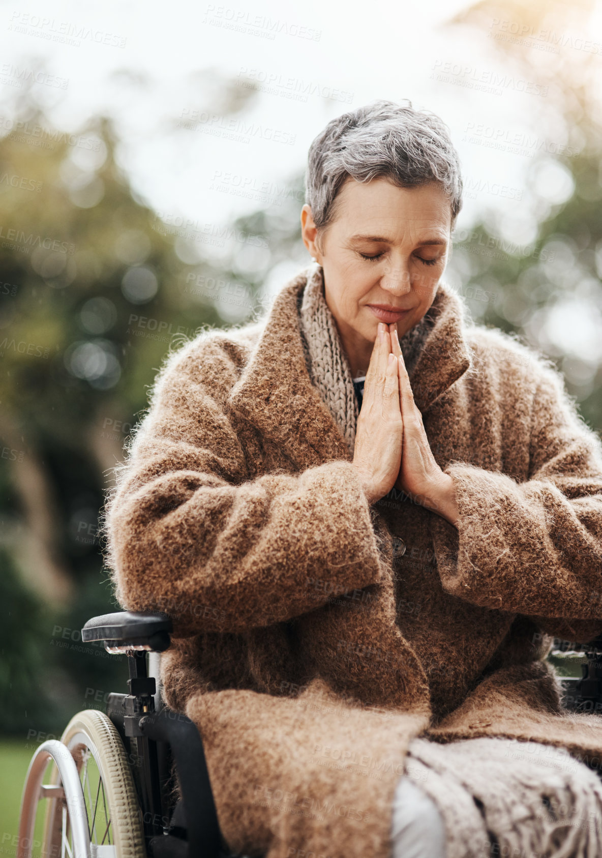 Buy stock photo Senior woman in wheelchair, praying in garden with worship and God, disability with gratitude and faith outdoor. Spiritual female person in nature with paralysis, disabled and prayer for guidance