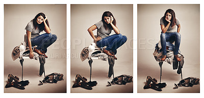Buy stock photo Composite shot of a thoughtful young woman choosing clothing piled on a chair against a brown background