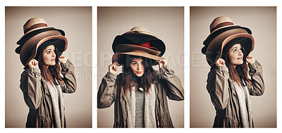 Buy stock photo Composite shot of a young woman wearing a pile of hats against a brown background